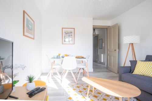 un salon avec un canapé bleu et une table dans l'établissement Danton Renaissance - F2 rénové - Tout équipé, au Havre