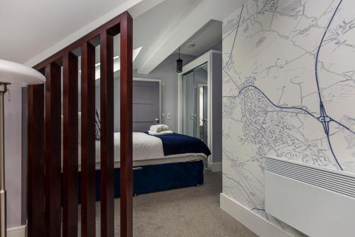 a bedroom with a bed with a map on the wall at Luxury Loft Apartment by Bootique Wakefield in Wakefield
