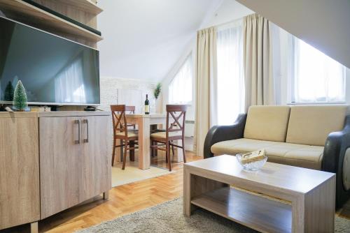 a living room with a large flat screen tv at Mountain apartments in Zlatibor