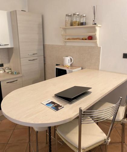 a kitchen with a table with a laptop on it at Casa Mia Apartment in Bellagio