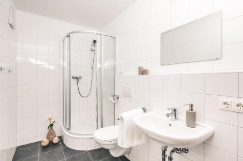 a white bathroom with a toilet and a sink at Obertauern Alps 4-Zimmer Appartement - Top 6 in Obertauern