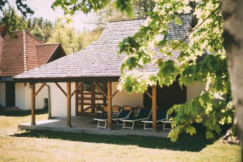 a gazebo with chairs and a table at Viesu nams Melnsils in Melnsils