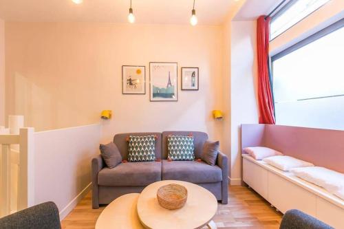 a living room with a couch and a table at New and Cosy in heart of Paris, 12e, 4pers in Paris