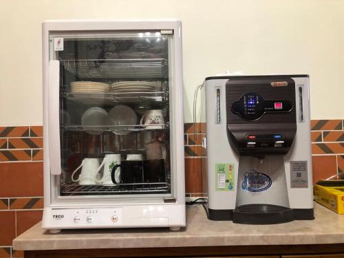 a refrigerator and a toaster on a counter at 金門后倉七號新古厝民宿 in Jinning