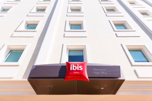 a hotel sign in front of a building at ibis Vientiane Nam Phu in Vientiane