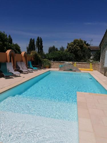 - une piscine avec des chaises longues dans l'établissement Domaine Des Deux Rivières - Gîte -, à Meilhan-sur-Garonne