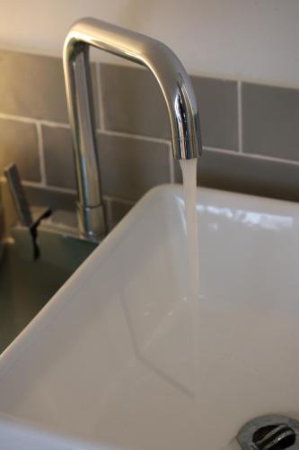 a sink with water coming out of a faucet at Pudswell Studio in Burford