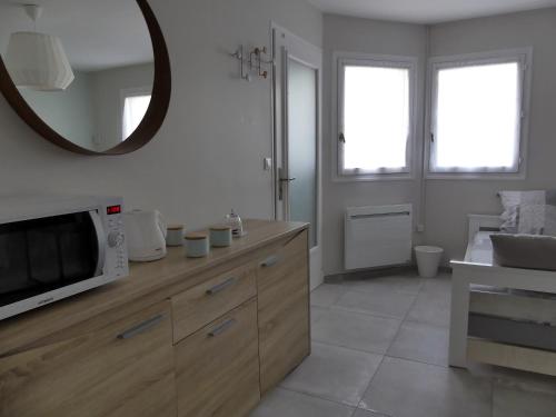 a kitchen with a microwave on top of a counter at Chambres D'hôtes Les Ambaciales in Amboise