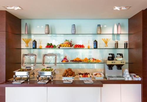 a buffet with fruits and vegetables on display at ibis Vientiane Nam Phu in Vientiane