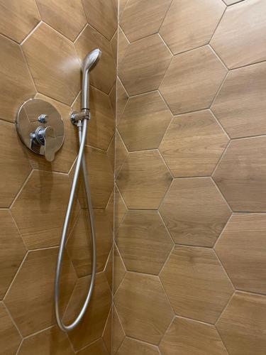 a shower head on a wall in a bathroom at Solunska Stylish Apartment in Sofia