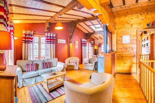 a living room with couches and chairs in a cabin at Chant du Coq - Chalet - BO Immobilier - remises sur les forfaits de skis Châtel ou Portes du soleil in Châtel