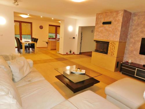 a living room with a white couch and a fireplace at Chalupa Staré Buky in Staré Buky