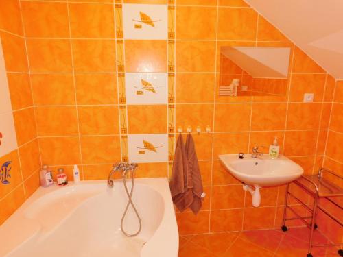 a bathroom with a tub and a sink at Chalupa Staré Buky in Staré Buky