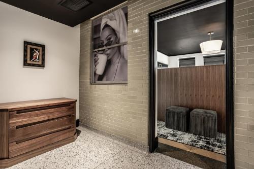 a bathroom with a picture of a woman playing a trumpet at Bottleworks Hotel in Indianapolis