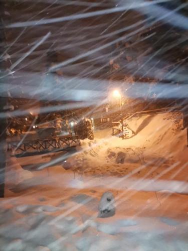 a view of a snow covered street at night at DMK in Divčibare