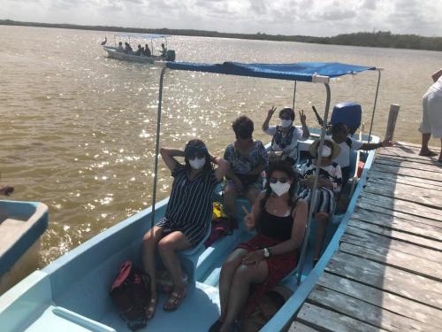 un grupo de personas sentadas en un barco en el agua en Hotel Posada Mercy, en Río Lagartos