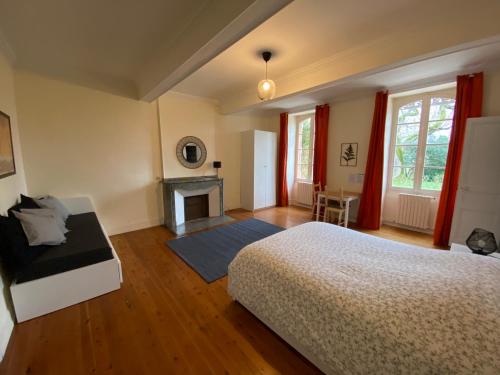 a bedroom with a bed and a fireplace at La Tarabelloise in Tarabel