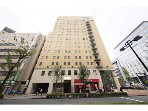 a large building on a city street with at R&B Hotel Shin Yokohama Ekimae - Vacation STAY 14695v in Yokohama