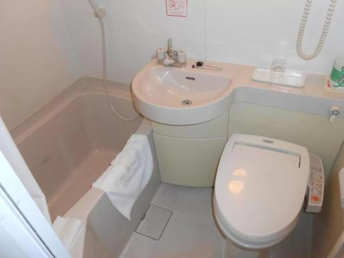 a bathroom with a toilet and a sink and a tub at R&B Hotel Kumagaya Ekimae - Vacation STAY 14848v in Kumagaya