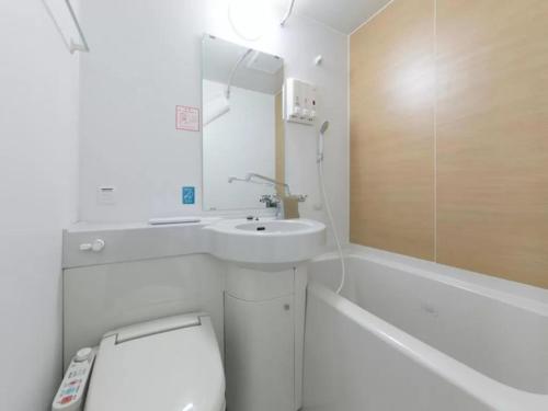 a white bathroom with a sink and a toilet at R&B Hotel Nagoya Shinkansenguchi - Vacation STAY 15002v in Nagoya