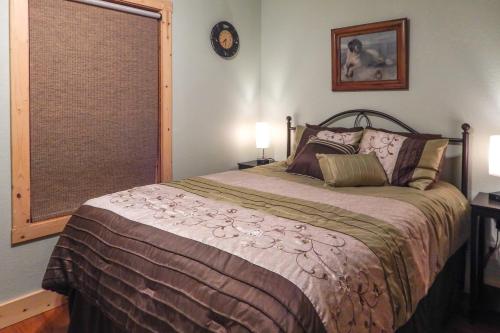 a bedroom with a bed and a window at Black Hills Cabin Hot Tub, Fishing Pond and Deck in Custer