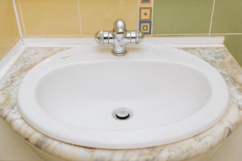 a white sink in a bathroom at Apartment in the Center in Sumy