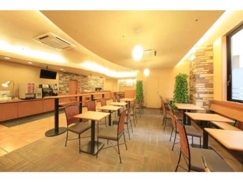 a restaurant with tables and chairs in a room at R&B Hotel Sendai Hirosedori Ekimae - Vacation STAY 15197v in Sendai