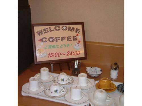 a table with cups and saucers and a sign at R&B Hotel Sendai Hirosedori Ekimae - Vacation STAY 15197v in Sendai