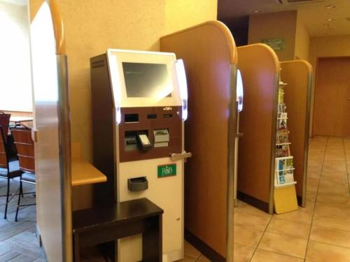 a ticket machine sitting in a room with at R&B Hotel Sendai Hirosedori Ekimae - Vacation STAY 15179v in Sendai