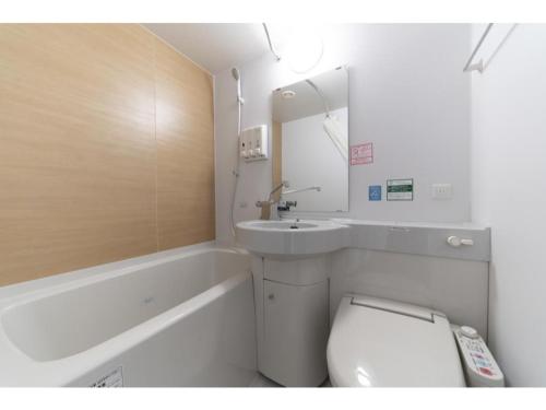 a bathroom with a toilet and a sink and a tub at R&B Hotel Hakata Ekimae 2 - Vacation STAY 16429v in Fukuoka
