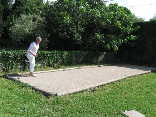a man standing on a concrete slab in the grass at La Grande Maison De Nans in Nans-les-Pins