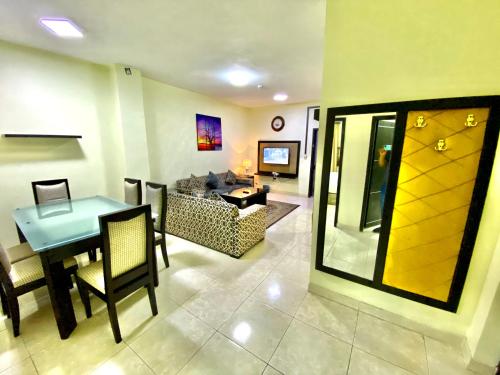 a living room with a table and a couch at Spring Tower in Al Jubail