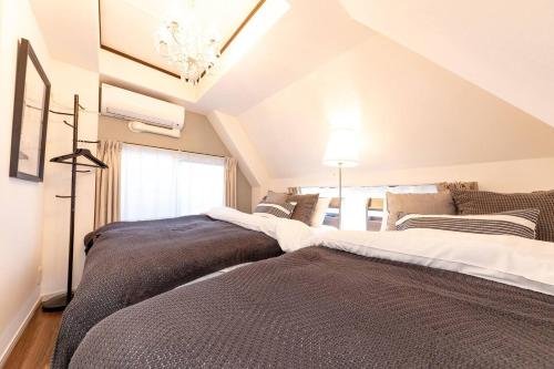 a bedroom with two beds in a attic at CASA SHINAGAWA UNO - Vacation STAY 18212v in Tokyo