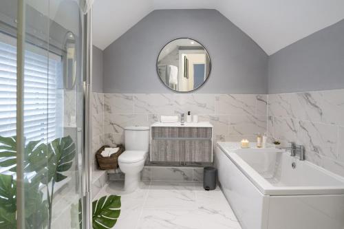 a bathroom with a sink toilet and a mirror at South View - 3 bed modern Chester house - Close to city centre in Chester