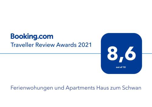 un cartel que lee los premios de revisión de viajeros con una plaza azul en Ferienwohungen und Apartments Haus zum Schwan, en Arnstadt