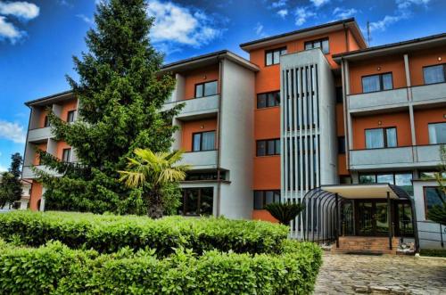 an orange building with a tree in front of it at Venafro Palace Hotel in Venafro