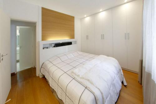 a bedroom with a bed and white cabinets at Leblon House Cupertino perto da praia portaria 24 h garagem ar condicionado e lava seca roupas in Rio de Janeiro