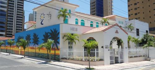 un edificio con un mural en el costado en Hotel Encontro do Sol en Fortaleza