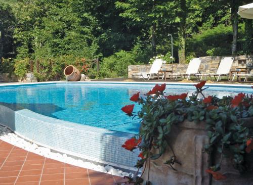 
a pool with a couple of people in it at Amalthia Traditional Guesthouse in Tsagarada
