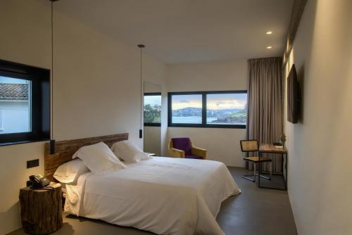 A bed or beds in a room at AFTER Hotel