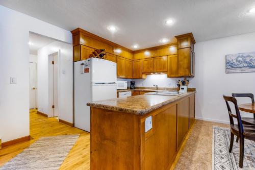 a kitchen with wooden cabinets and a white refrigerator at Owen D in Jackson