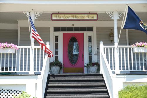 a house with a pink door and an american flag at Harbor House Inn in Grand Haven