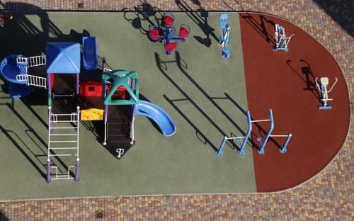 an overhead view of a playground with a play equipment at Odesa Pearl Apartments in Odesa