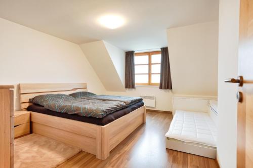 เตียงในห้องที่ Horský apartmán U Lesa Říčky