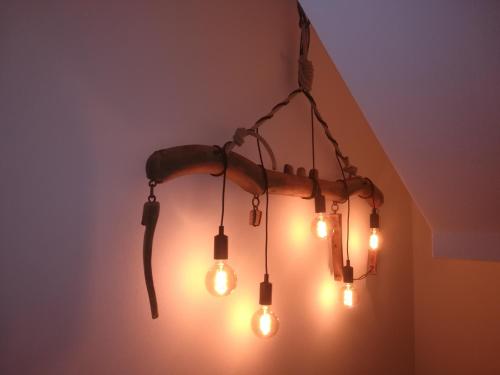 a chandelier with lights hanging from a ceiling at Albergo Alpino in Vermiglio