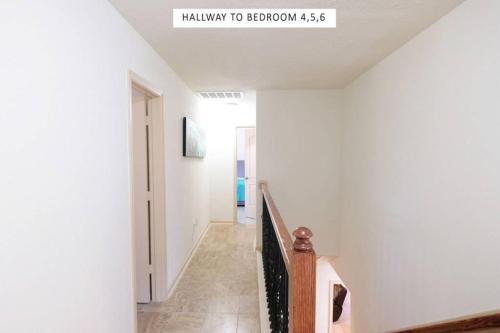 a white hallway with a stairway to freedom at Vacation Pool House in the Serene Wilderness - Robert E Lee in Conroe