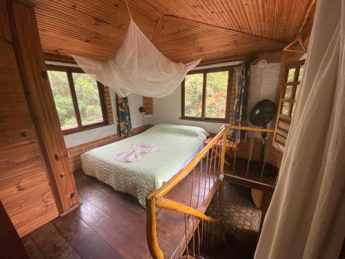 Ένα ή περισσότερα κρεβάτια σε δωμάτιο στο Chalé Morro Branco