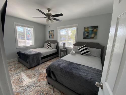 a bedroom with two beds and a ceiling fan at Main House 3 Bed 2 Bath & Guest House 1 Bed 1 Bath in Miami