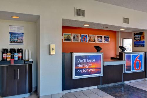 a waiting room with a sign in a restaurant at Motel 6-Cocoa Beach, FL in Cocoa Beach