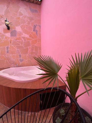 a bathroom with a sink and two palm trees at Casa Rosa Hotel & Spa in San Cristóbal de Las Casas